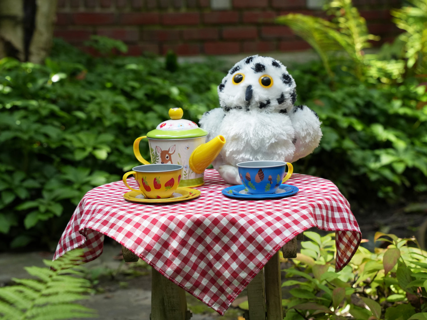 image of tea set and stuffed owl