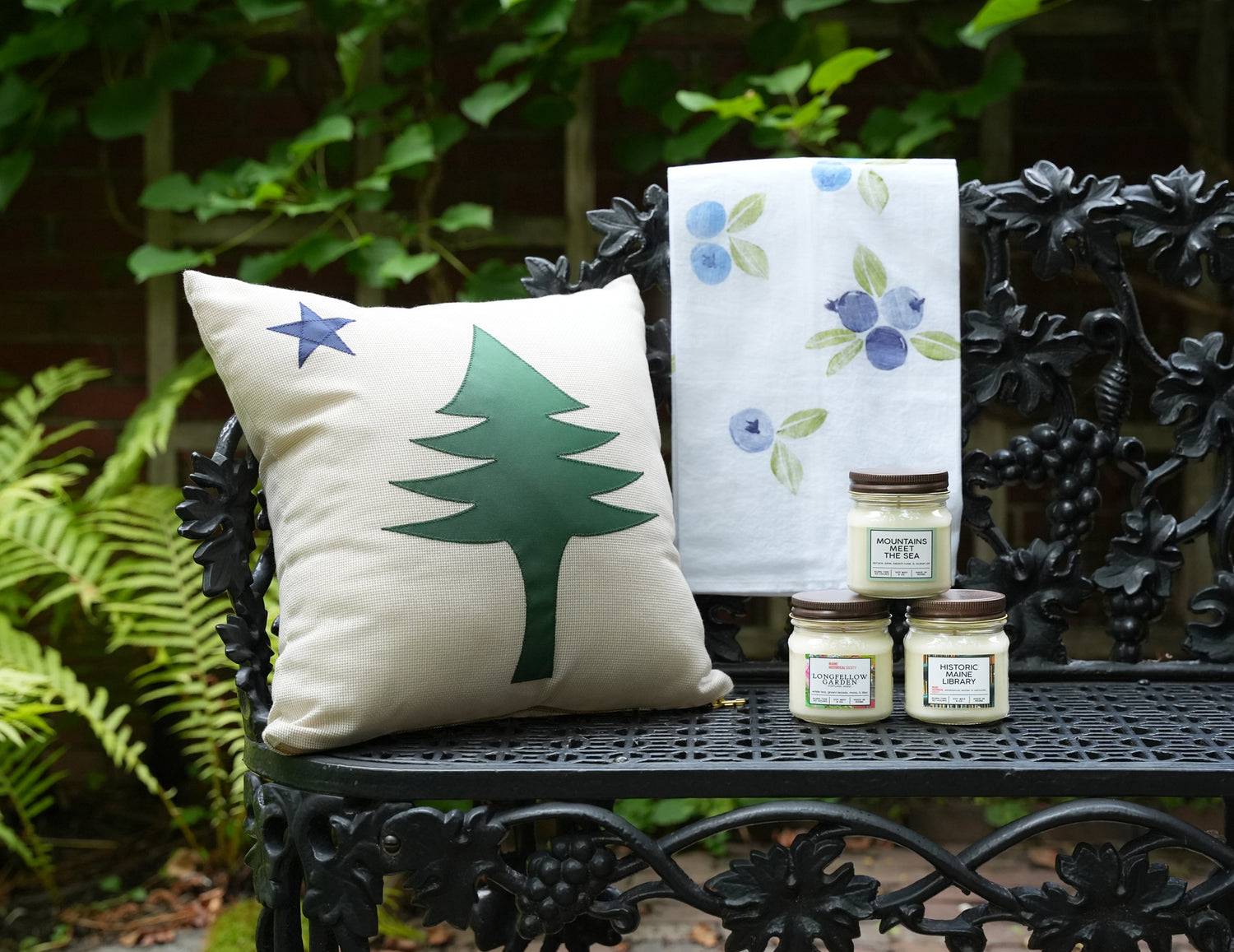 images of pillow towel and candles on bench